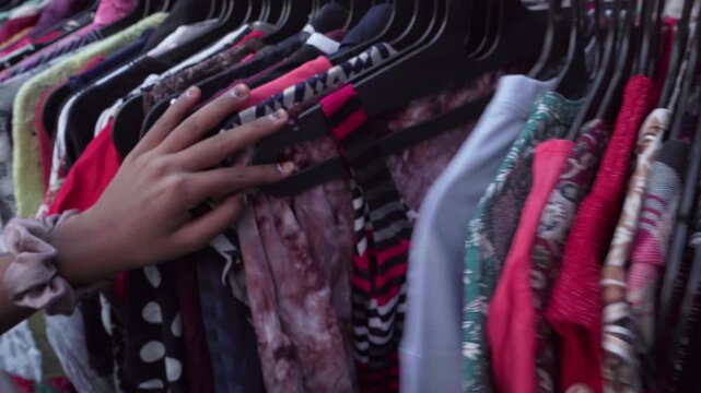 Colorful Indian ethnic wear on clothing racks at a local flea market in India. Traditional garments and textiles