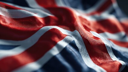 Waving, textured fabric displaying the UK flag's bold red, white, and blue