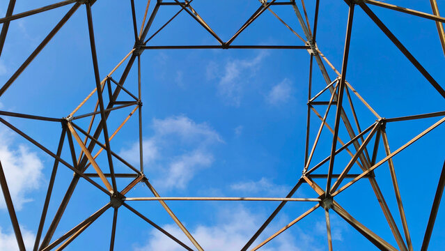 Transmission tower under cloudy blue sky. High voltage electric transmission pole (3)