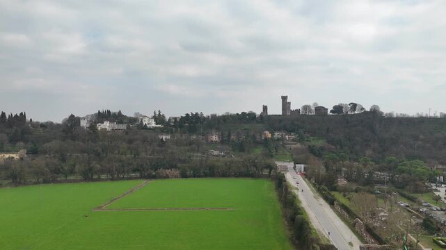 Valeggio sul Mincio with the Visconti Bridge and Borghetto riverside hamlet, showing the Mincio River, weir, historic mills and hillside towers above the town in Veneto, northern Italy