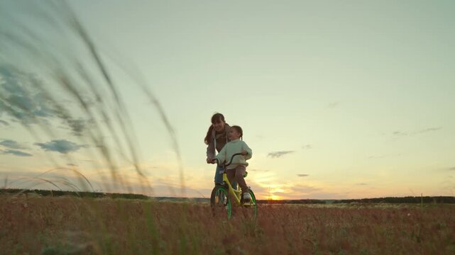 Magical sunset memories, Teaching life skills, Family field trip, Enjoying freedom, Parental trust, Fresh air biking, Learning to let go, Childhood adventure, Guiding with love, Sharing happy times
