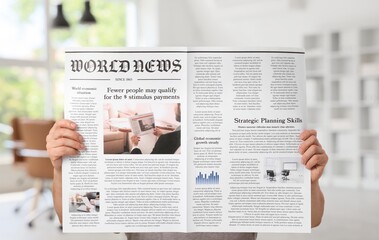 Naklejka premium Man reading newspaper at home