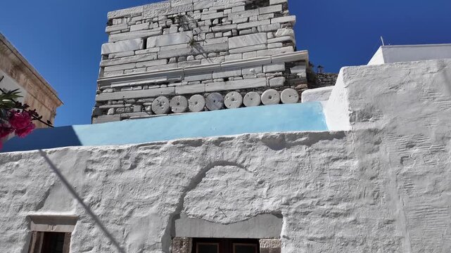 Cyclades,Paros Island,Tilt up from bottom to top of Frankish Castle of Paroikia with the details of the stones used, building the tower on a sunny day.