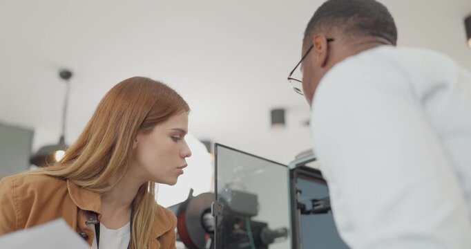 A diverse team of startup professionals collaborates on a 3D printing project in a modern workspace. Highlighting innovation, teamwork, and the prototyping process in a creative tech environment.
