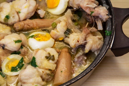 monkfish, casserole in green sauce with asparagus, egg and potatoes