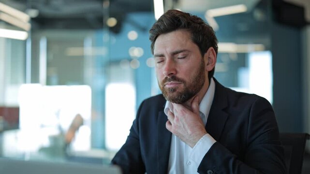 Professional experiences noticeable sore throat and discomfort while working in modern office. Feeling unwell, finding it difficult to concentrate on tasks, showing concern about health.