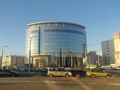 Modern glass building of the Faculty of International Relations of Belarusian State University at Railway Station square on a sunny winter day in Minsk, 2014 