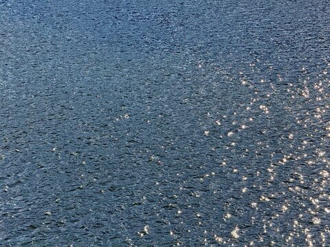 Blue river calm water background.