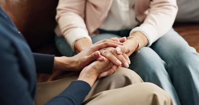 Caregiver, holding hands and people in home with help, understanding or trust in retirement care. Compassion, security or elderly person in house with comfort, support and empathy in assisted living.