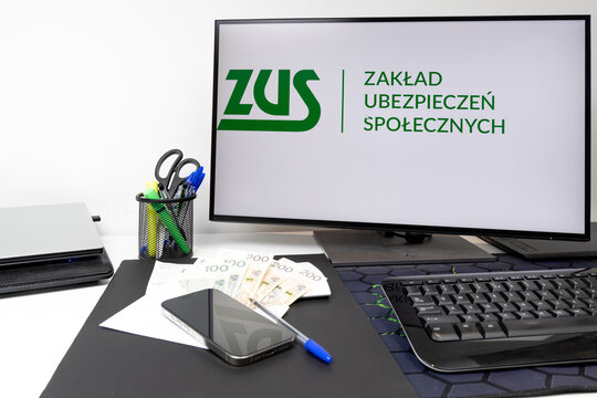 Czestochowa, Poland - February 19, 2026: Monitor with displayed ZUS website, social security contribution, computer keyboard, desk, banknotes,