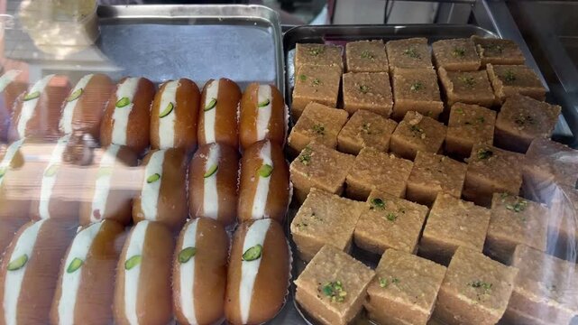 Chamcham, sandesh, and rabri are sold in a sweet shop in Kolkata, India