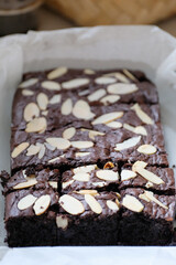 Authentic homemade chocolate brownies topped with crunchy sliced almonds