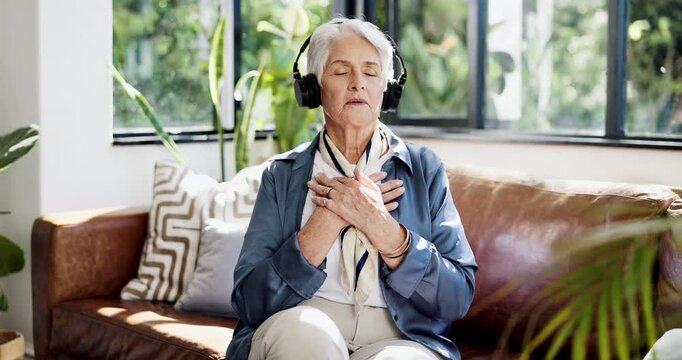 Headphones, breathing or senior woman on couch, meditation guide track or listening for relaxation. Exhale, audio instructions or old person with tech in home, mindfulness narrative or center energy