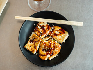 Fried tofu with soy sauce and spices, cooked according to a Chinese recipe. Delicious Asian dish for lunch