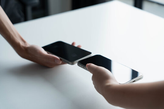 Man using smartphone close contect transfer file by wireless technology