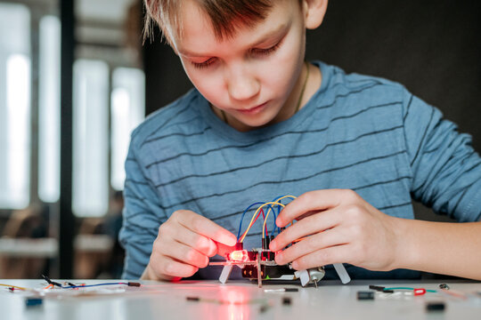 Boy assembling robot at home