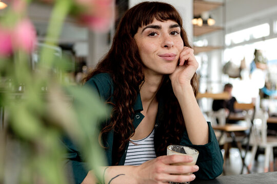 Portrait of confident young woman in a cafe