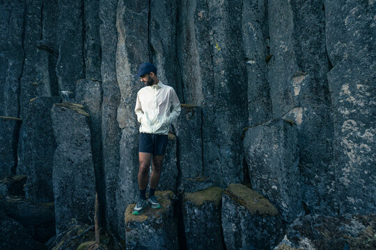 Trail Runner Standing on columnar basalt volcanic rock