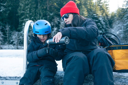 Mother and Child Drinking Hot Chocolate After Skating