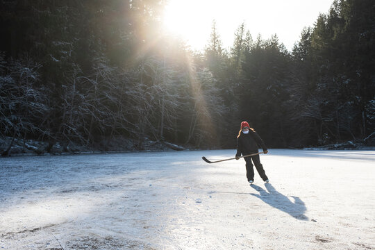 Ice Skater Gliding Across Frozen Water