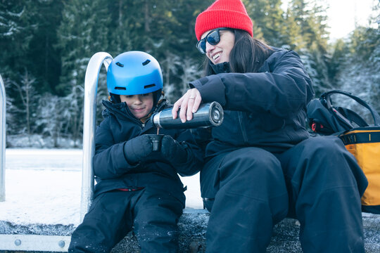 Mom and son Drinking Hot Chocolate After Skating