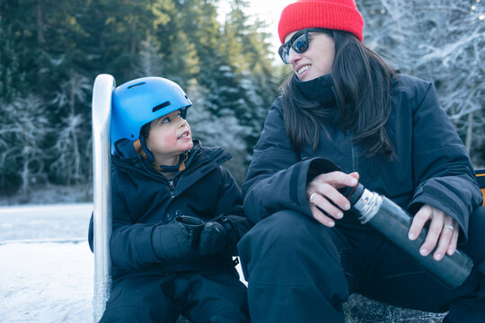 Mom and son Drinking Hot Chocolate After ice Skating