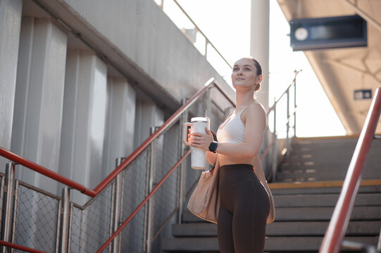 Fitness Woman with Water Bottle on Stairs