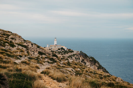 Distant View Of Formentor Lighthouse On Rocky Cliffs, Cap de Formentor