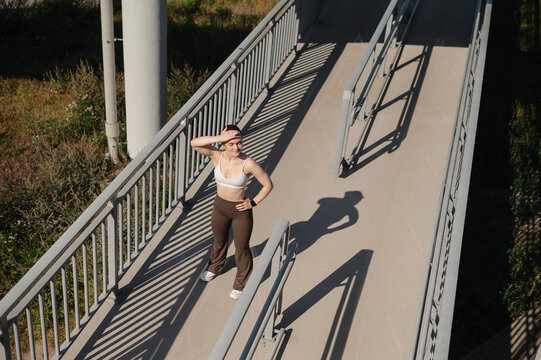 Fitness Woman Exercising on Outdoor Bridge