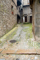 Narrow cobblestone street with stone buildings.. La Alberca, in the province of Salamanca, Spain