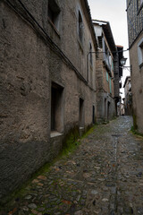 Fototapeta premium Narrow cobblestone street between old stone buildings.. La Alberca, in the province of Salamanca, Spain