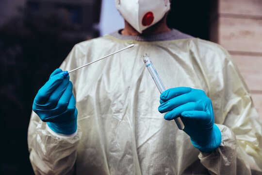 Healthcare worker holding swab test kit for PCR testing