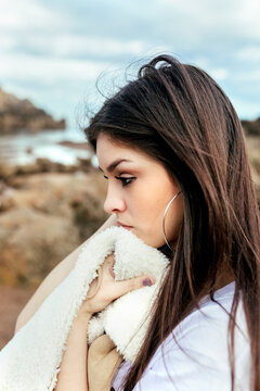 Sad young woman on the beach