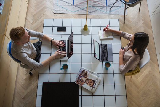 Couple with laptops working at home
