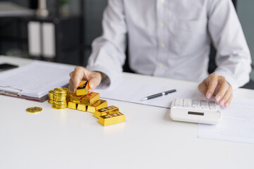 Gold bar Trading business people hand offering gold&nbsp;Investment in gold mining company or Trading gold on the stock exchange&nbsp;Rising prices.