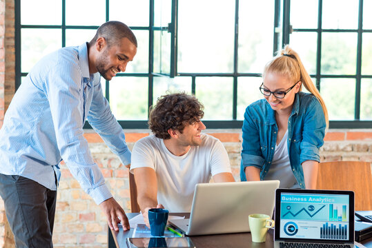 Young professionals working together in start up company, developing a business plan