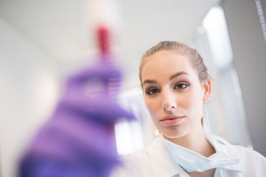 Scientist in lab examining blood sample
