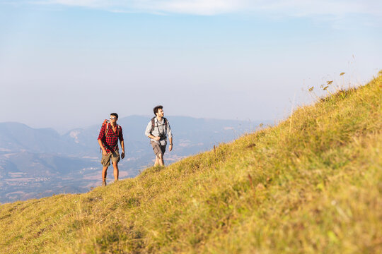 Italy, Monte Nerone, two men hiking in mountains in summer