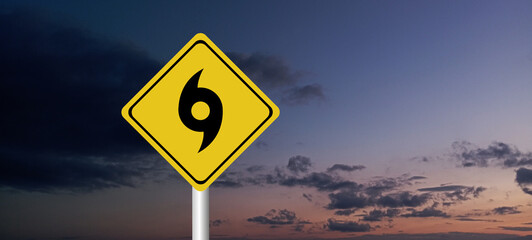 Hurricane Idalia warning sign against a powerful stormy background with copy space. Dirty and angled sign with cyclonic winds add to the drama.hurricane season sign on cloudy background