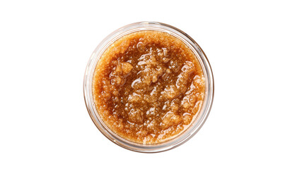 Overhead shot of a small, clear glass jar filled with brown, grainy substance