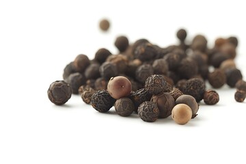 Pile of black peppercorns on white background for culinary use