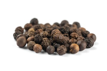 Pile of whole black peppercorns on white background