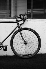 Monochrome Bicycle Leaning Against a Concrete Wall