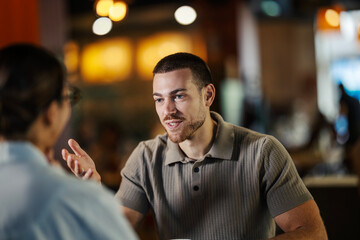 Young man having conversation in a cafe