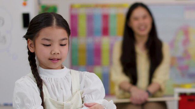 Young Girl Learning to Tell Time in Classroom Activity