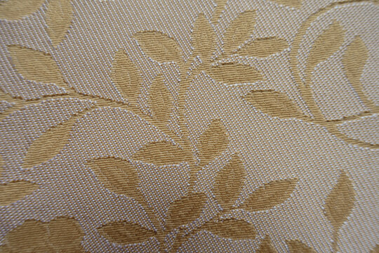 Close view of beige and white single damask jacquard fabric