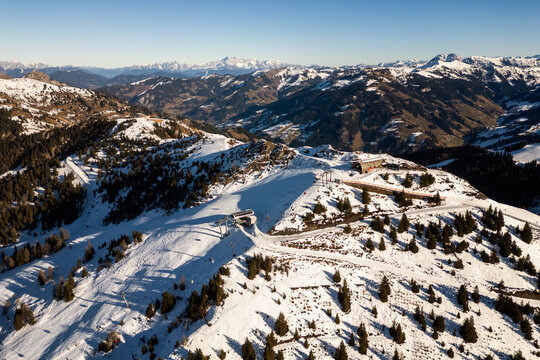 Aerial view of ski slopes at Dorfgastein ski resort in Gasteinertal valley, part of Ski Amade, showing snowy Alpine ridge and scenic winter panorama.