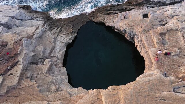 Above aerial slow motion view of Giola lagoon, natural pool near the sea, in Thassos island, Greece