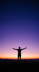 Silhouette of person with arms raised against colorful sky, representing freedom, achievement, and connection with nature and open space for content