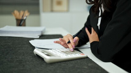 Business accounting concept, Business woman using calculator, budget and loan paper in office